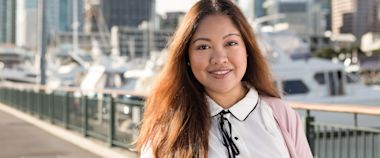 An international student smiling in a bridge